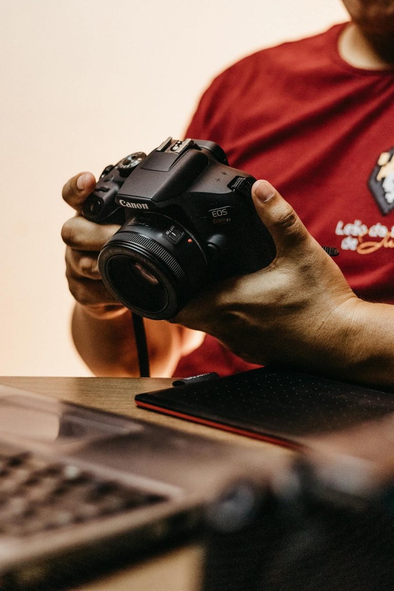 Man Holding Camera in Had